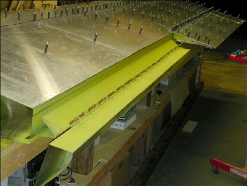 Drill and cleco the aileron hinge to the aileron support channel