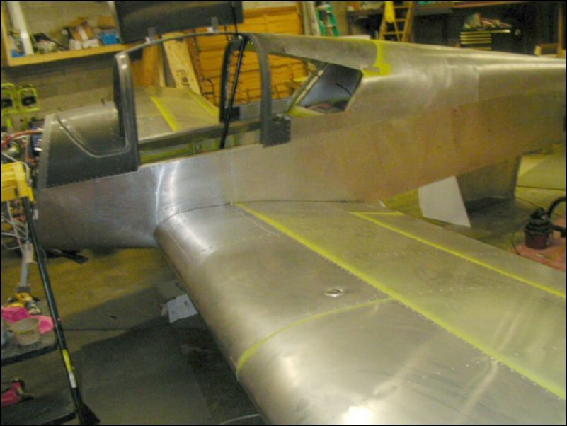 Rivet skin over fuel tank 