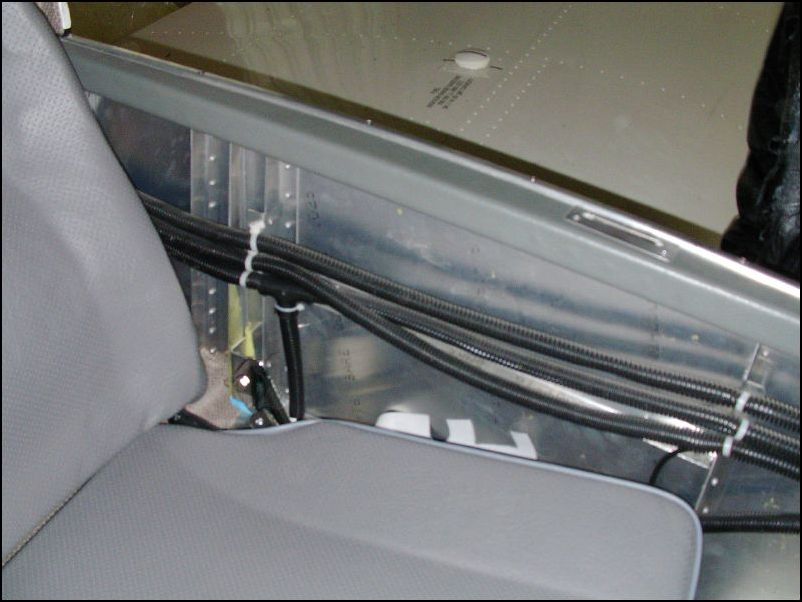 Wires run along pilots side of fuselage.