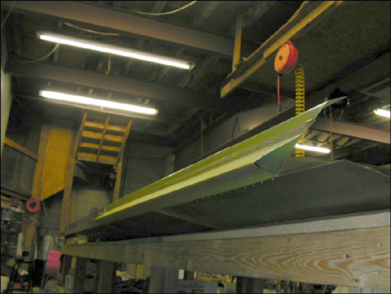 Deburr, clean, prime, and rivet the aileron support channel to the rear channel.