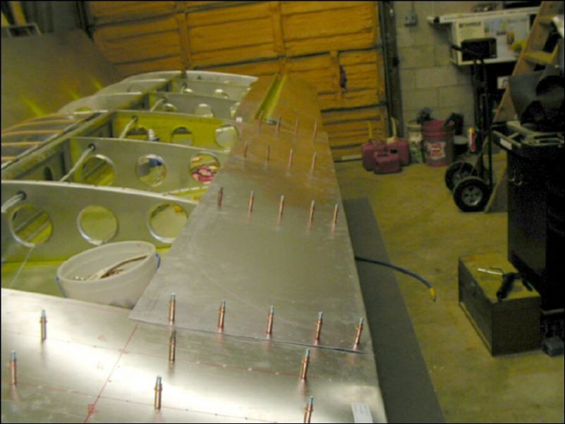 Drill and cleco the trailing edge skin.