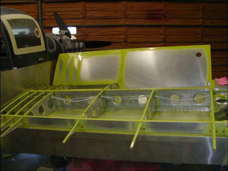 Debur, clean, and prime wing ribs and skins.